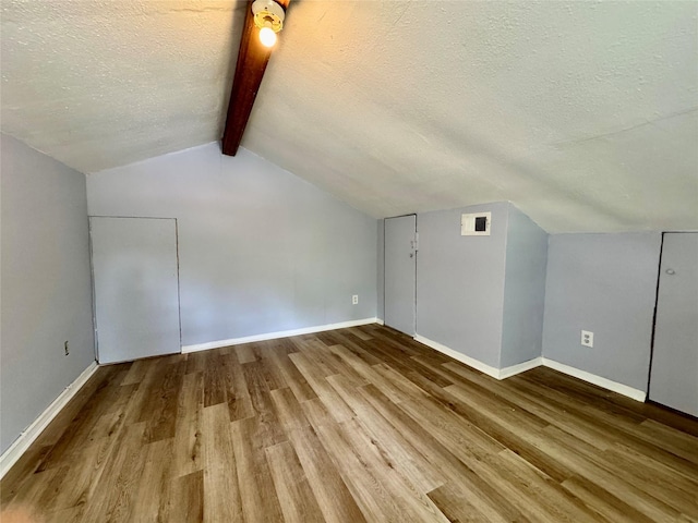 18 Townhouse Ln Unit 18, Trinity, TX 75862 - bonus room with wood finished floors, a textured ceiling, and baseboards