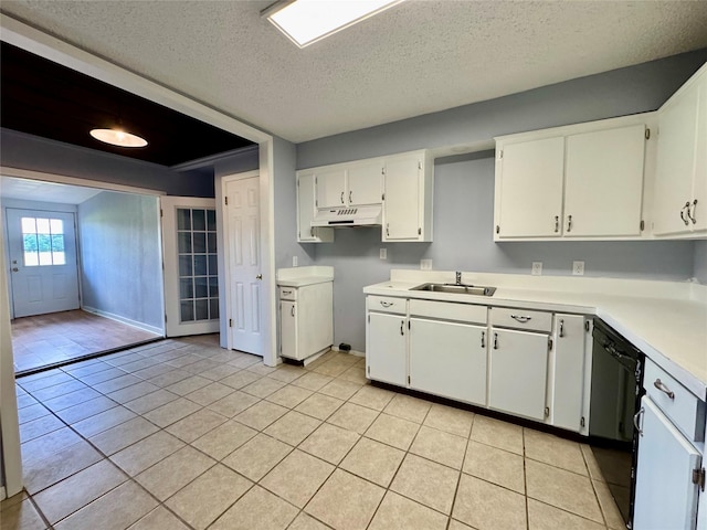 18 Townhouse Ln Unit 18, Trinity, TX 75862 - kitchen featuring under cabinet range hood, a sink, a textured ceiling, white cabinetry, and light countertops