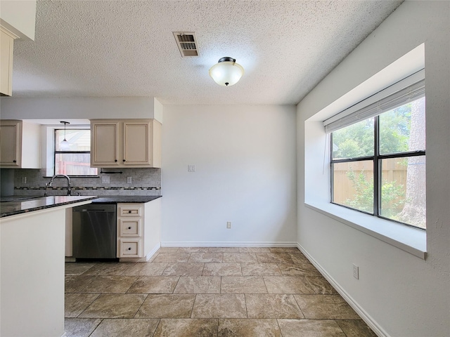 18515 Sweetmeadow Dr, Spring, TX 77379 - kitchen with dishwasher, dark countertops, tasteful backsplash, healthy amount of natural light, and a textured ceiling