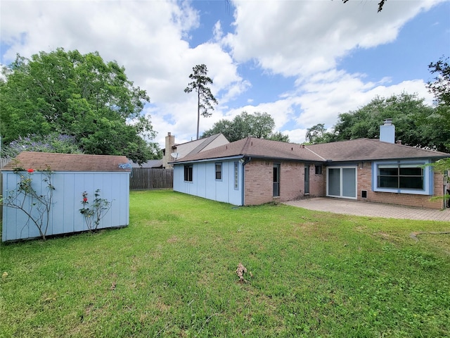 18515 Sweetmeadow Dr, Spring, TX 77379 - back of house featuring a patio, brick siding, a shed, an outbuilding, and a chimney