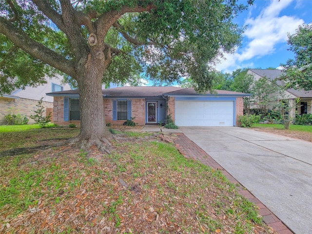 18515 Sweetmeadow Dr, Spring, TX 77379 - ranch-style house featuring a garage, brick siding, and driveway