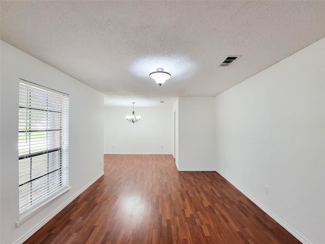 18515 Sweetmeadow Dr, Spring, TX 77379 - spare room with a chandelier, wood finished floors, a textured ceiling, and baseboards