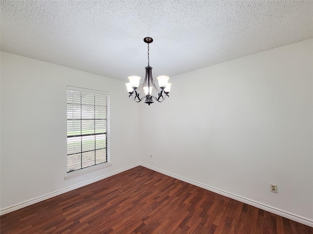18515 Sweetmeadow Dr, Spring, TX 77379 - unfurnished room featuring a chandelier, dark wood-style floors, baseboards, and a textured ceiling