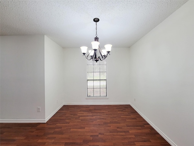 18515 Sweetmeadow Dr, Spring, TX 77379 - unfurnished room with a chandelier, dark wood-type flooring, baseboards, and a textured ceiling
