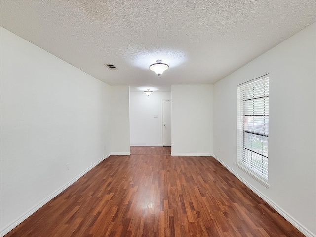 18515 Sweetmeadow Dr, Spring, TX 77379 - empty room featuring wood finished floors, a textured ceiling, and baseboards
