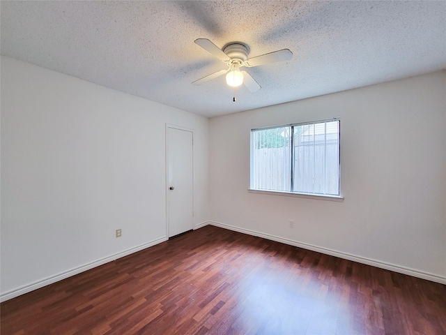 18515 Sweetmeadow Dr, Spring, TX 77379 - spare room featuring dark wood-style flooring, ceiling fan, baseboards, and a textured ceiling