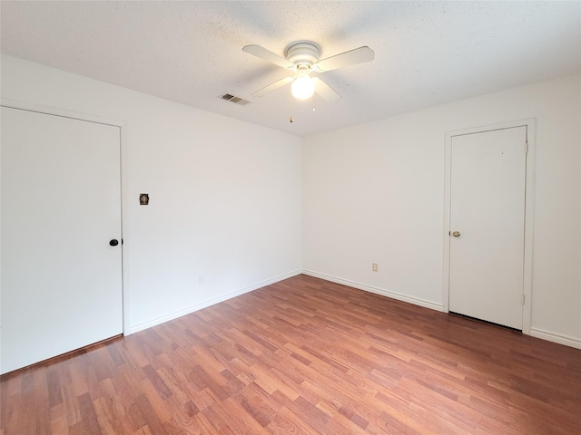 18515 Sweetmeadow Dr, Spring, TX 77379 - empty room with a ceiling fan, light wood-style flooring, baseboards, and a textured ceiling