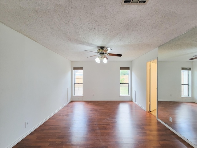 18515 Sweetmeadow Dr, Spring, TX 77379 - empty room with a ceiling fan, a textured ceiling, wood finished floors, and healthy amount of natural light