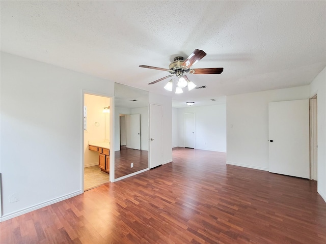 18515 Sweetmeadow Dr, Spring, TX 77379 - unfurnished room with light wood-style floors, a ceiling fan, a textured ceiling, and baseboards