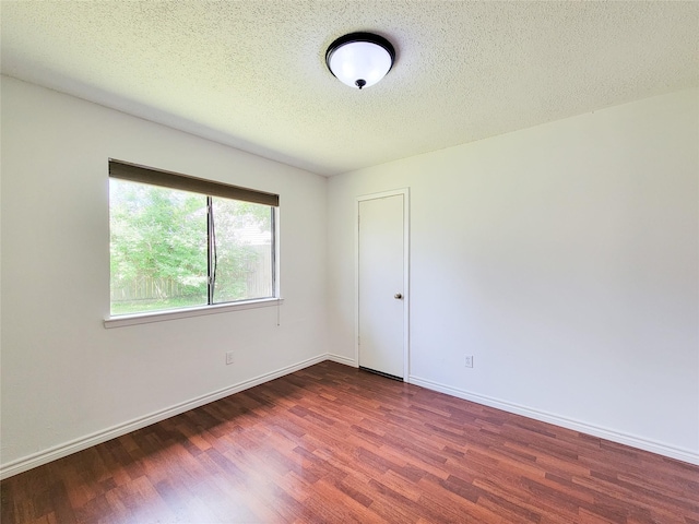 18515 Sweetmeadow Dr, Spring, TX 77379 - unfurnished room featuring wood finished floors, baseboards, and a textured ceiling