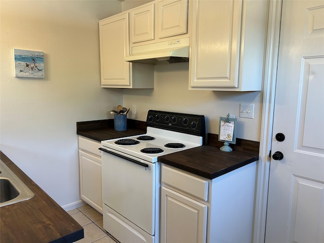 2610 Daugherty St, Waller, TX 77484 - kitchen featuring electric stove, under cabinet range hood, butcher block countertops, light tile patterned floors, and white cabinets