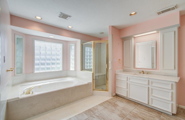 full bathroom with a shower stall, vanity, a bath, recessed lighting, and tile patterned flooring