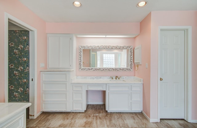 full bath featuring baseboards, vanity, and recessed lighting