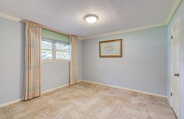 empty room featuring crown molding, a textured ceiling, and baseboards