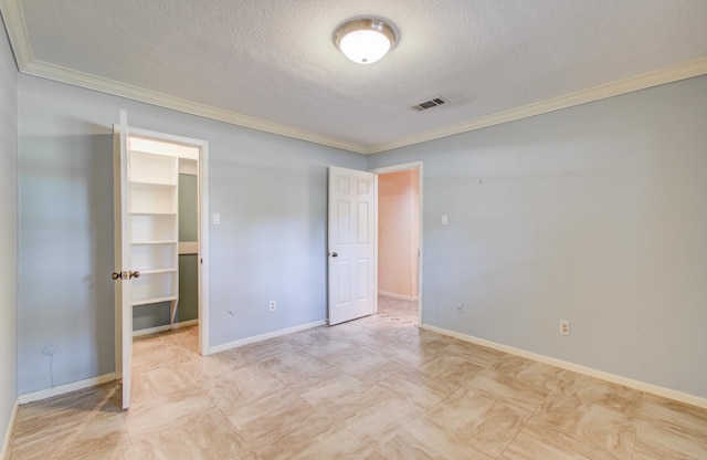 unfurnished bedroom with crown molding, a textured ceiling, and baseboards