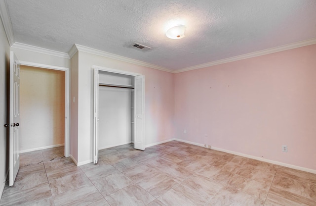unfurnished bedroom with a textured ceiling, crown molding, a closet, and baseboards