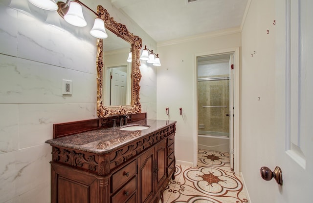 bathroom with vanity, shower / bath combination with glass door, ornamental molding, and tile patterned flooring