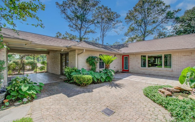view of front of house with brick siding and fence