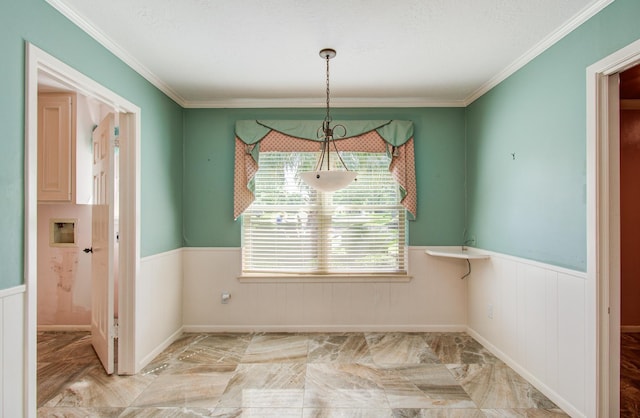 unfurnished dining area with wainscoting, marble finish flooring, and crown molding
