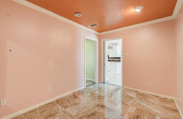unfurnished room featuring light marble finish flooring, baseboards, and crown molding