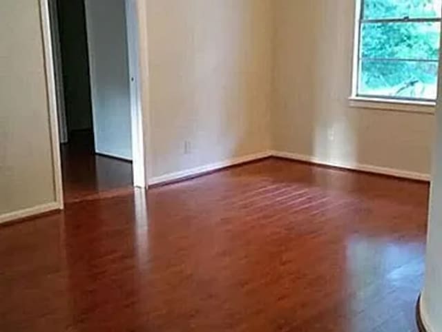 406 Poinsetta St, Lake Jackson, TX 77566 - empty room featuring wood finished floors and baseboards