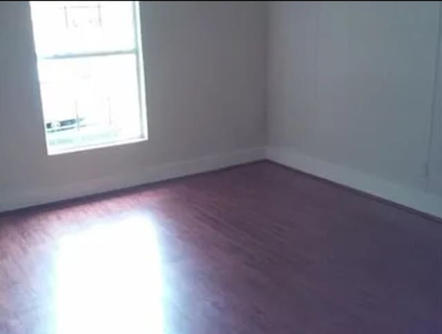 406 Poinsetta St, Lake Jackson, TX 77566 - empty room with wood finished floors and baseboards