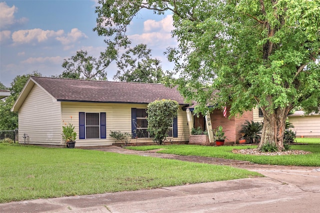 406 Poinsetta St, Lake Jackson, TX 77566 - ranch-style house featuring a front lawn and a shingled roof
