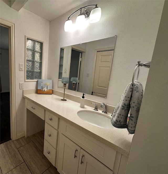 bathroom with vanity and wood finished floors
