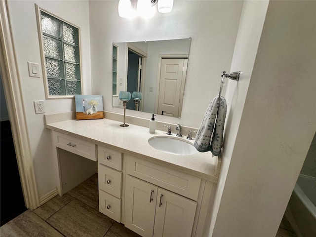 bathroom with vanity and a tub to relax in