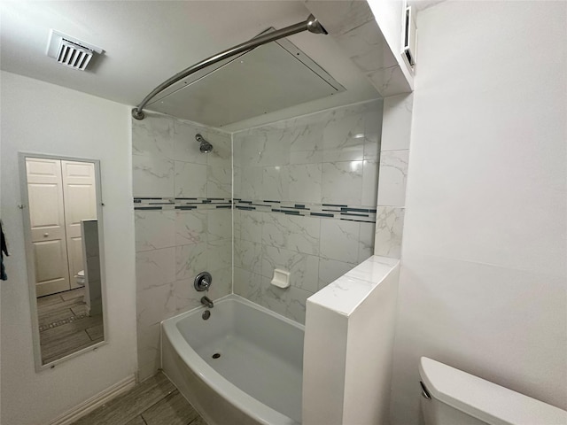 bathroom featuring toilet and  shower combination