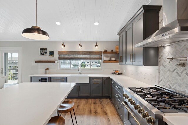 30 N Curlew St, La Marque, TX 77568 - kitchen with wall chimney exhaust hood, high end range, a sink, decorative backsplash, and open shelves