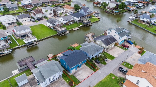30 N Curlew St, La Marque, TX 77568 - aerial view of residential area with property parcel outlined and a large body of water