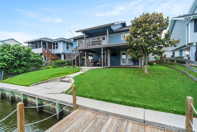 30 N Curlew St, La Marque, TX 77568 - back of house featuring a deck with water view and stairs