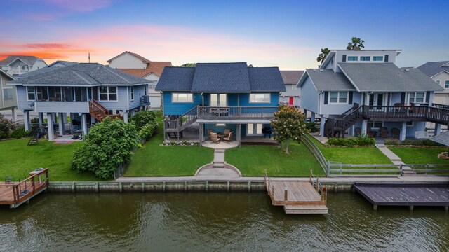30 N Curlew St, La Marque, TX 77568 - back of house with stairway, a patio area, a deck with water view, and a residential view