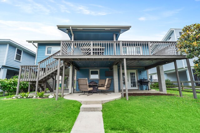 30 N Curlew St, La Marque, TX 77568 - back of house featuring a deck, a lawn, a patio, and stairs