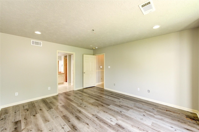 6613 Whitton Dr, Houston, TX 77085 - unfurnished room with recessed lighting, light wood-style floors, baseboards, and a textured ceiling