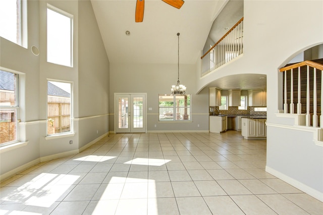 6613 Whitton Dr, Houston, TX 77085 - unfurnished living room featuring high vaulted ceiling, ceiling fan, a chandelier, light tile patterned flooring, and baseboards