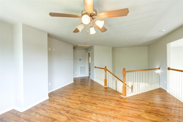 6613 Whitton Dr, Houston, TX 77085 - unfurnished room with attic access, wood finished floors, ceiling fan, and baseboards