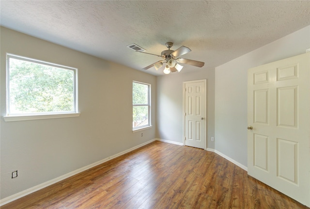 6613 Whitton Dr, Houston, TX 77085 - empty room featuring a ceiling fan, wood finished floors, baseboards, and a textured ceiling