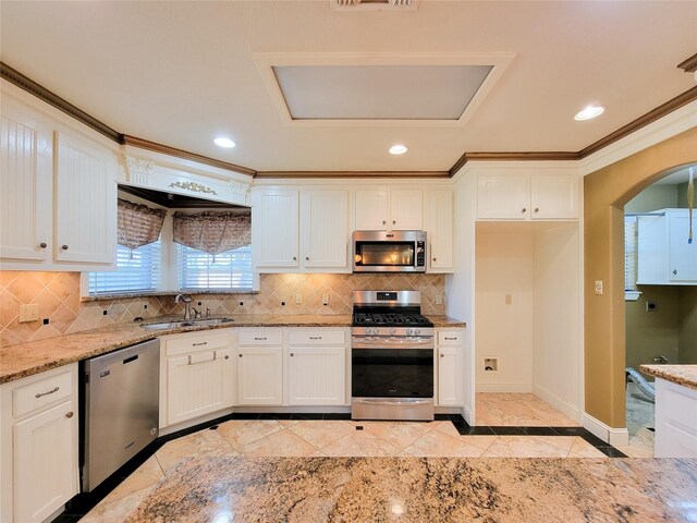 719 Partridge Ln, Eagle Lake, TX 77434 - kitchen featuring appliances with stainless steel finishes, a sink, crown molding, inlaid floor details, and light stone counters
