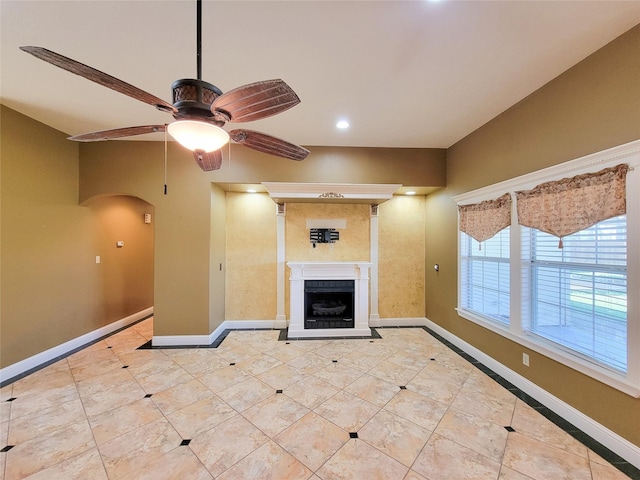 719 Partridge Ln, Eagle Lake, TX 77434 - unfurnished living room with baseboards, a ceiling fan, arched walkways, a fireplace, and recessed lighting