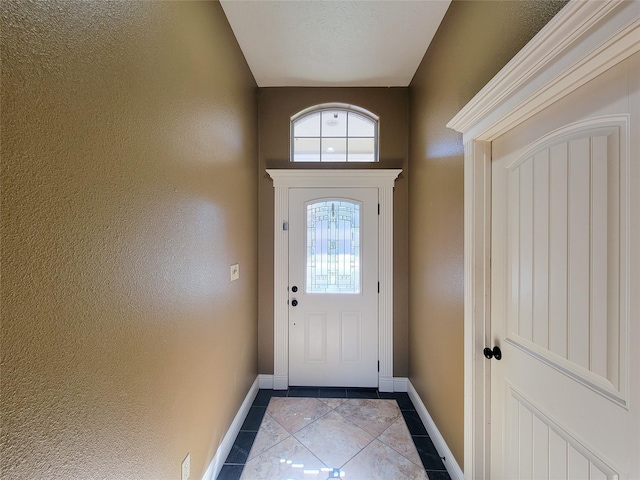 719 Partridge Ln, Eagle Lake, TX 77434 - doorway to outside featuring baseboards, plenty of natural light, and a textured wall