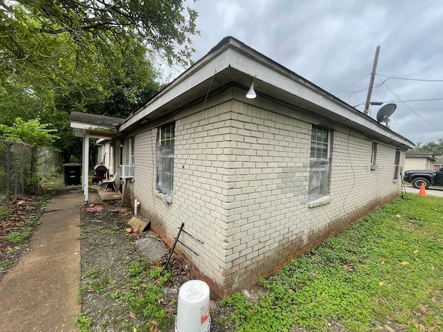 5118 Mallow St, Houston, TX 77033 - view of side of property featuring brick siding, fence, and cooling unit