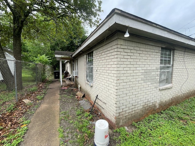 5118 Mallow St, Houston, TX 77033 - view of side of property featuring brick siding, fence, and cooling unit