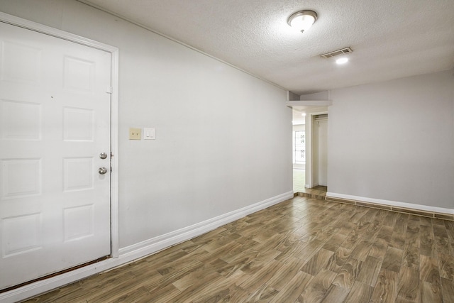 9923 Valley Sun Dr, Houston, TX 77078 - unfurnished room featuring a textured ceiling, wood finished floors, and baseboards