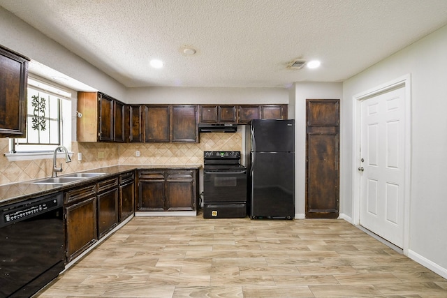 9923 Valley Sun Dr, Houston, TX 77078 - kitchen with black appliances, exhaust hood, a sink, dark brown cabinetry, and decorative backsplash