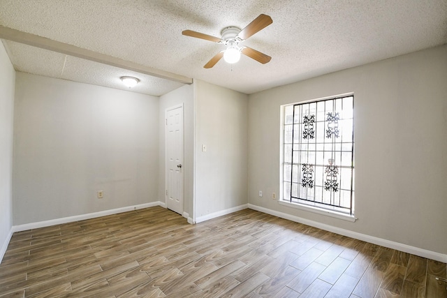 9923 Valley Sun Dr, Houston, TX 77078 - empty room featuring a ceiling fan, wood finished floors, a textured ceiling, and baseboards
