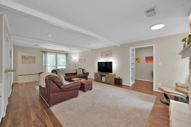 living area with beam ceiling and dark wood-type flooring