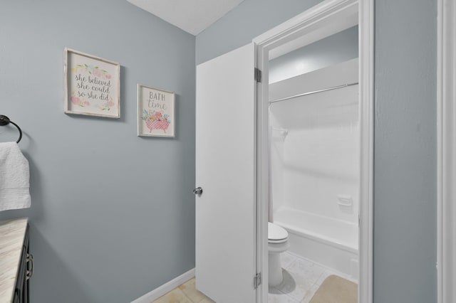 bathroom featuring toilet, tile patterned flooring, and bathing tub / shower combination