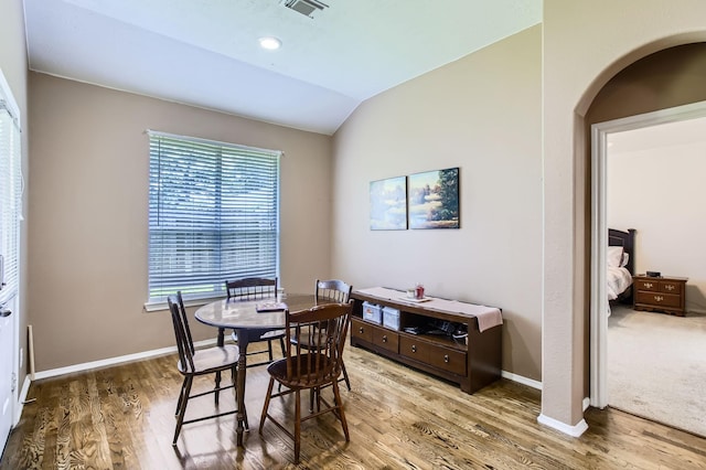 18115 Linden Forest Ln, Katy, TX 77449 - dining area featuring arched walkways, wood finished floors, lofted ceiling, and baseboards